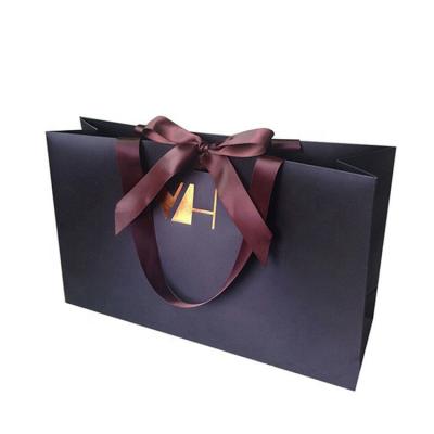 China Hot Foiled Logo Stamping Black Matte Paper Bags Recyclable With Ribbon Handles for sale