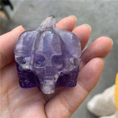 China Feng Shui Natural Hand Carved Fluorite Pumpkin Shape Skull Carving Crystal Skulls Ornament For Gift for sale