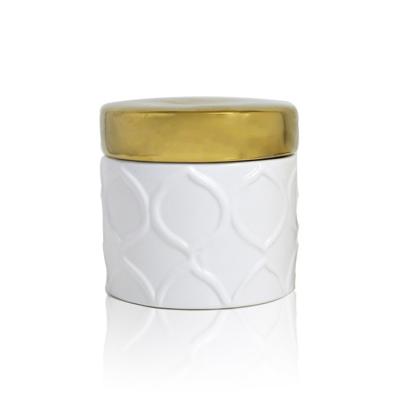 China Popular scented maker holiday 150g aromatherapy candle in white emboss ceramic jar with gold lid for sale