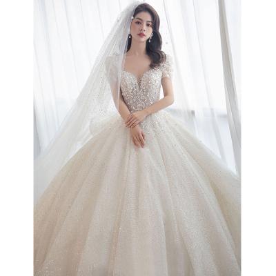 China Luxury Short Sleeve Wedding Dress Dry Cleaning With Sexy V-Neckline Big Sweep Train Bridal Dress New Beading Ball Gown Shinning Bridal Dress for sale