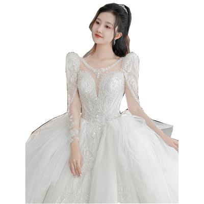 China Luxury Dry Cleaning Train New Luxury Beading Wedding Dress See Through Long Sleeve Lace Applique Princess Wedding Gown With Pearl for sale