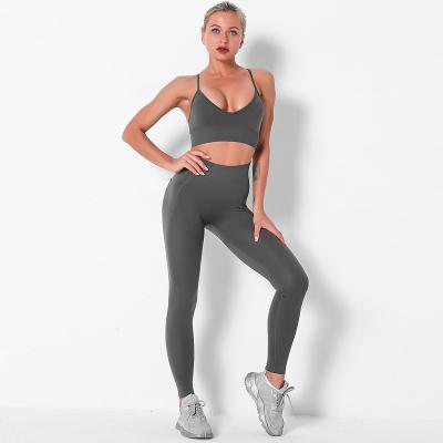 China Breathable Women's Workout Gym Wear Yoga Suit 2 Piece Seamless Women Yoga Tights Bra Cutout Pants Set To Customize OEM Sports Working Uniform for sale