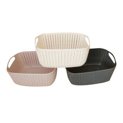 China Sustainable Style Rectangular Wicker Hollow Rattan Portable Home Plastic Storage Basket With Handle for sale