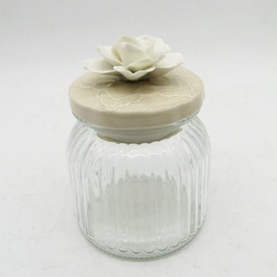 China Food Grade Sustainable Transparent Glass Jam Jar With Flower Shape Ceramic Lid for sale