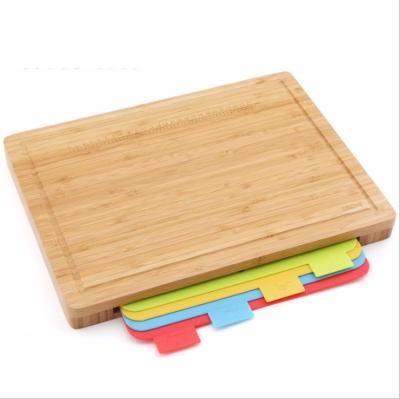 China Large Viable Kitchen Classify Bamboo Cutting Board With 4 Mat Dividing Rule And Silicone Legs for sale