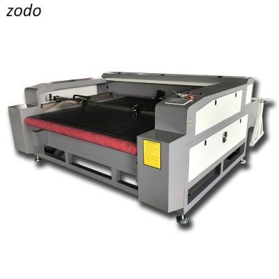 China LASER CUTTER 1600*1000mm 1610 ccd_laser_cutting_130w 150w 180w autofeed fabric textile cloth cnc co2 laser cutting machine machine for sale