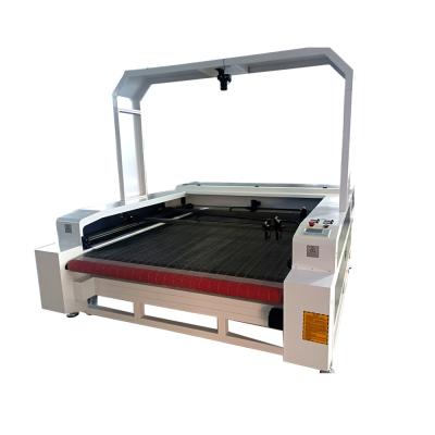 China LASER CUTTER 1600*1000mm 1610 130w 150w 180w Autofeed Cloth Textile Fabric CO2 Laser Cutting Machine With Full Panoramic CCD Camera for sale