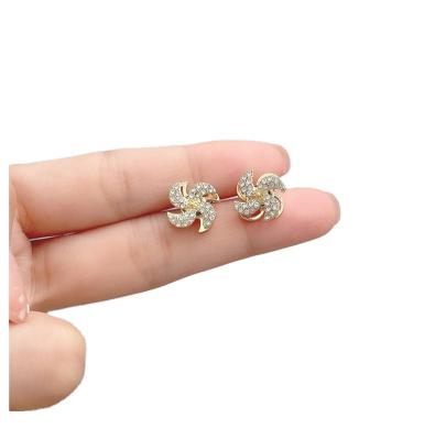 China FASHIONABLE Rotating Temperament Women's Net Red Rhinestone Gold Rhinestone Windmill American Unique Earrings 925 Silver Needle Tide Earrings for sale