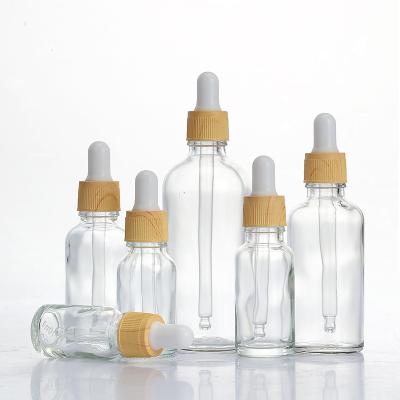 China Personal Care 5ml 10ml 15ml 20ml 30ml 50ml 100ml Essential Oil Glass Bottles Logo Bamboo Ring Dropper Bottle Custom Essence Hydrosol for sale