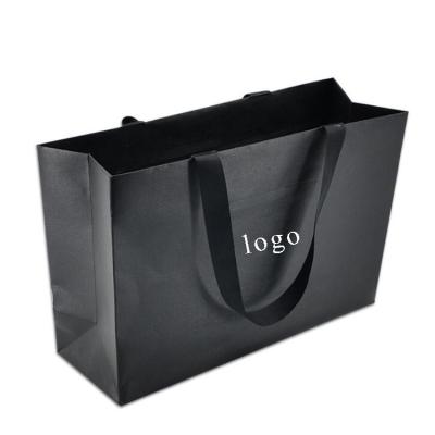 China Recycled Materials Black Kraft Paper Bags With Black Ribbon Handle Custom Logo Packaging Paper Bags For Clothing And Shopping Gift for sale