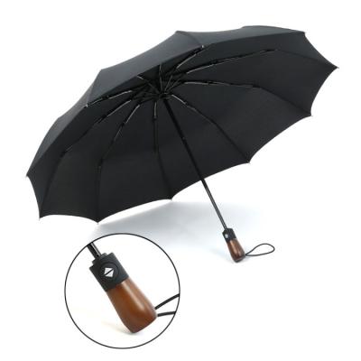 China 10k weatherproof custom wooden handle triple folding umbrella for sale