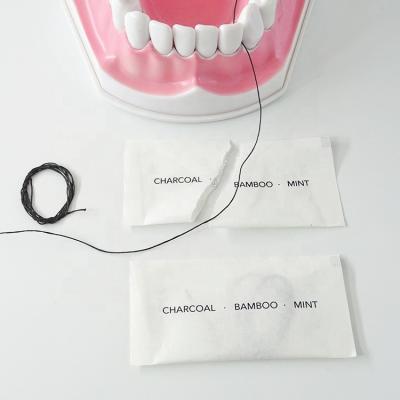 China Bamboo Charcoal Dental Floss Hotel Travel Use Disposable Dental Floss In Paper Bag for sale