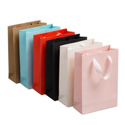 China Recycled Materials Free Sample Logo Luxury Pink Cardboard Paper Custom Bag With Ribbon Handle for sale