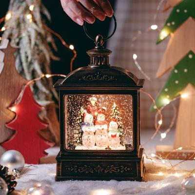 China In New Stock Christmas Decoration Kanggang Resin Cartoon Snowball Snow Globe Square Built-in Christmas Lantern for sale