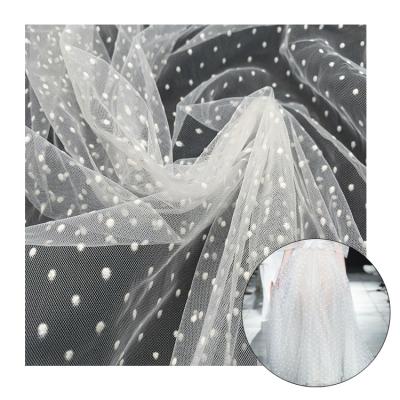 China Breathable Custom Design Knitted Lady Big White Dots Wholesale Flocked Tulle Mesh Fabric for sale