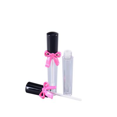 China Newest Cosmetics Makeup Packing Bottle With Bowknot Empty Lip Gloss Tube Container With Brush for sale