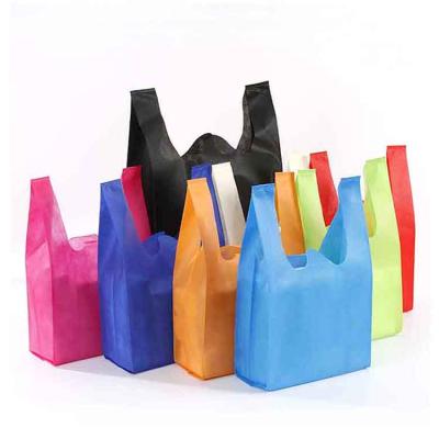 China Disposable Moisture Proof Biodegradable Eco W Cut Non Woven Fabric Vest Shopping Bags for sale