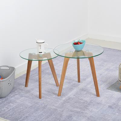 China Eco - Friendly Modern Fancy Round Transparent Wooden Legs Tempered Glass Top Coffee Table Furniture for sale