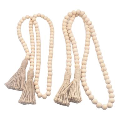 China 100% Handmade Farmhouse Wood Beads Garland with Tassels Wall Hanging Christmas Garland Beads for Living Room Decor for sale