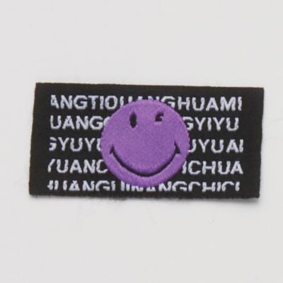 China Other purpule embroideried simle face clothing label leather patch label for garment accessories for sale