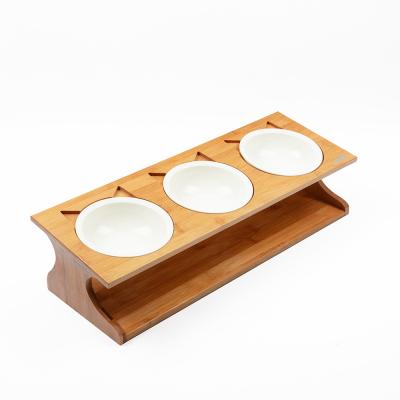 China Solid Bamboo Rack Stocked With Three Pet Table Ceramic Bamboo Pet Bowls for sale