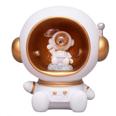 China Folk Art Hot Selling Creative Resin Figures Astronaut Resin Open Piggy Bank Sculpture Ornament Living Room Table Decoration Binding Box for sale