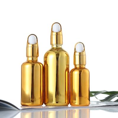 China 30ml shiny cosmetics plate gold dropper glass bottles for essential oil serum packaging for sale