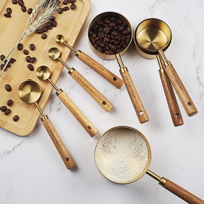 China Stocked 8PCS Set Stainless Steel Gold Finished Measuring Cups And Spoons With Wooden Handle Cups Style Measuring Cups Set for sale