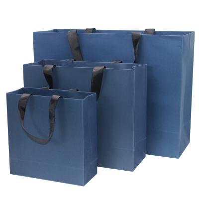 China Custom Colored Rose Print Gift Bag Paper Bag Royal Blue Packaging Eco-friendly Recyclable Logo Wide Base Boutique Shopping For Apparel for sale