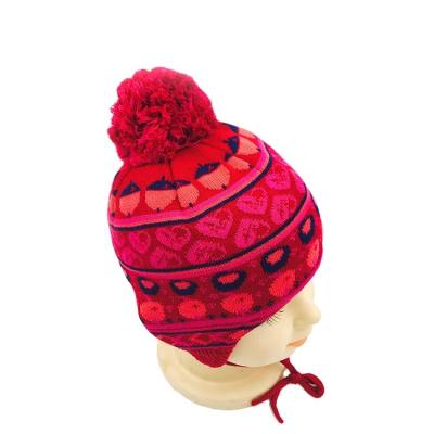 Китай Customized children's heart nut pattern jacquard color winter woolen knitted hat with fur ball decoration продается