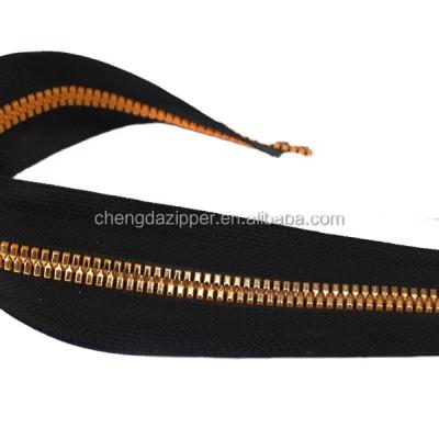 China Automatic Lock Plastic Zipper With Imitate Metal Gold Teeth Wholesale for sale