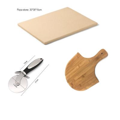 China Stored Ceramic Cordierite Pizza Stone Set With Pizza Cutter Bamboo Pizza Paddle Skin Tray Shovel for sale