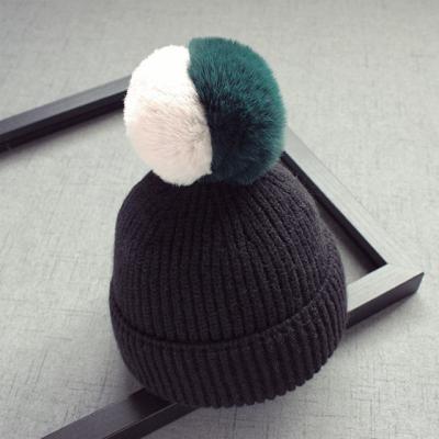 China NEW COMMON 2021 Large Faux Rabbit Fur Pompom Baby Hats Wholesale Price Black Baby Knit Hat Winter for sale