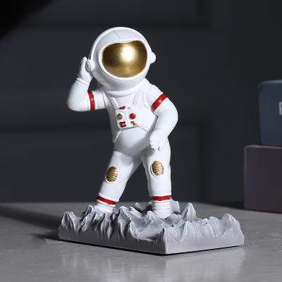 China Creative Cell Phone Waterproof Resin Holder Mobile Phone Stand Astronaut Mobile Phone Display Stand for sale