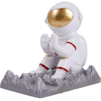 China Cell Phone Waterproof Stand Resin Holder Spaceman Mobile Phone Astronaut Resin Craft Lazy Gift for sale