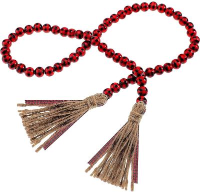 China 100% Handmade Natural Wood Bead Plaid Christmas Garland With Tassel Macrame Wall Hanging Decorations 2021 for sale