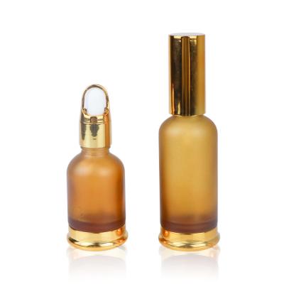 China Personal Care 30ml 50ml Sample Golden Glass Cosmetic Container For Essential Oils Fragrance for sale