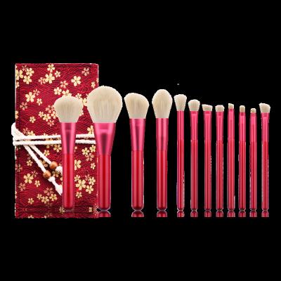 China Angular Blush 12pcs Rhinestone Ruby Brush Handle Goat Hair Makeup Set Brush With Red PU Bag for sale