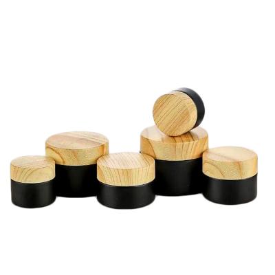 China Wholesale Cosmetic 5g 10g 15g 30g 50g 100g Black Matte Bottle For Cosmetics Packaging Glass Cream Jars With Wood Grain Bamboo Plastic Lid for sale