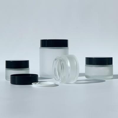 China Skin Care Cosmetic Packaging 5g 10g 15g 30g 50g 100g 100ml Glass Clear Frosted Jar With Plastic Black Lid for sale