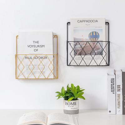 China Creative storage wholesale wrought iron wall hanging book rack newspaper and magazine wall decoration home shelf for sale