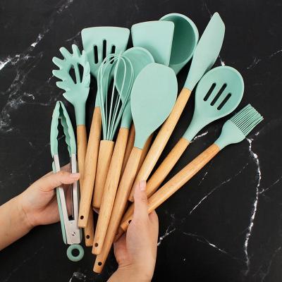 China Silicone Stocked Cookware Set Cooking Utensils Set 12Pcs Food Grade Safety Silicone Utensils With Wooden Handles for sale