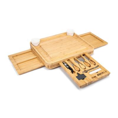 China Sustainable Charcuterie Tray Bamboo Cheese Cutting Board with Cutlery Set Meat Serving Tray with Slide-Out Puller Juice Grove for sale