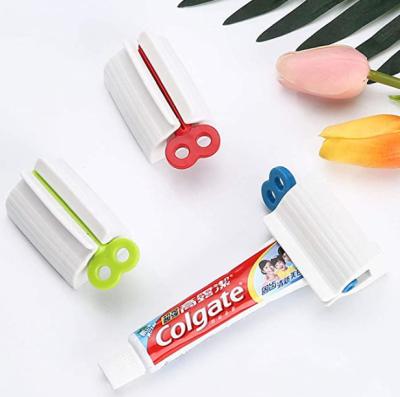 China Novelty Plastic Toothpaste Squeezer Rack Holder Bathroom Accessories 3 Colors for sale