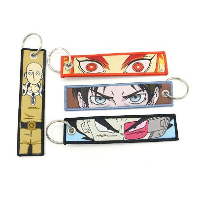 China Promotioanal Gifts/Give Away Fashion Personalized Anime Woven Embroidery Marker Key Chain With Metal Keychain Customization for sale