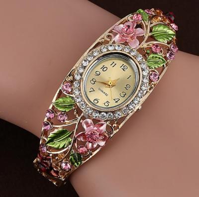 China Alarm Bracelet Watches Gold Plated Wrist Watch Crystal Flower Women Bracelet Dress Quartz Movt for sale