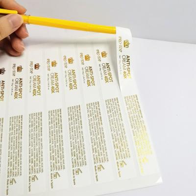 China Custom Waterproof Gold Foil Sticker Logo White Vinyl ANTI-SPOT CREAM 40X Die Cutting Machine for sale