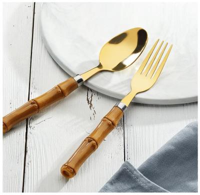 China Sustainable INS Style Food Grade Flatware Spoon Fork Modern Wooden Look Stainless Steel Cutlery Set Plastic Handle for sale