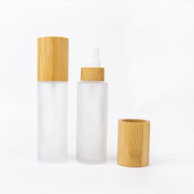 China 30ml 50ml 100ml Cosmetic Toner Lotion Cosmetics Luxury Clear Frosted Glass Bottles With Bamboo Lid for sale