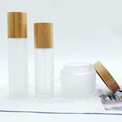 China Hot Sale Cosmetic Packaging 15g 30g 50g 100g Round Cosmetic Bamboo Lid Transparent Glass Frosted Empty Jars For Lotion Creams for sale